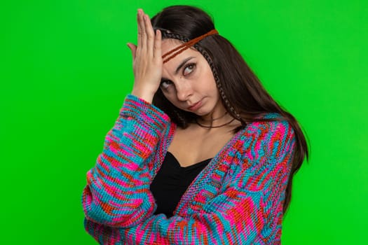 Face palm. Shame on you. Upset disappointed young woman making face palm gesture, feeling bored, disappointed in result, bad news. Hippie girl isolated on chroma key background, green screen, indoors