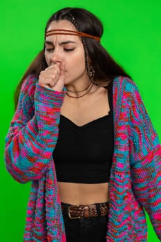 Unhealthy young woman coughing covering mouth with hand, feeling sick, allergy or viral infection symptoms, fever pain virus. Pretty hippie girl isolated alone on chroma key background, green screen