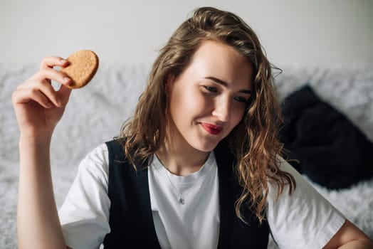 Happy Young Woman Multitasking with TV and Snacks, Relaxing Home Entertainment, Technology and Comfort, Lifestyle and Leisure, Unconscious Eating Habits Concept