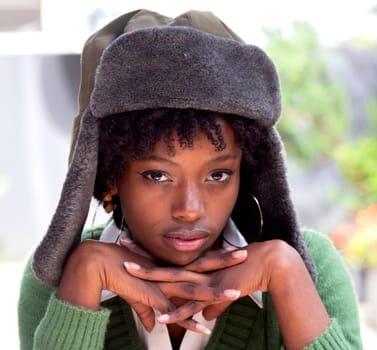 closeup of afro girl with military hat looking at camera