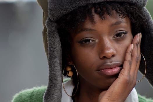 closeup of afro girl with military hat looking at camera