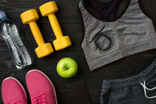 Sports accessories for fitness on the wooden floor. Healthy lifestyle concept. Top view