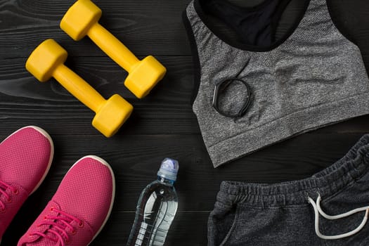 Sports equipment and wear on dark wooden background, top view. Copy space Still life. Ideal for blog.