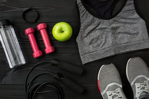 Sports equipment and wear on dark wooden background, top view. Copy space Still life. Ideal for blog.