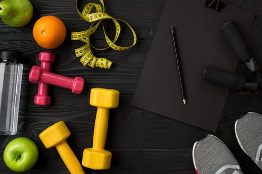 Sports equipment and wear on dark wooden background, top view. Copy space Still life. Ideal for blog.