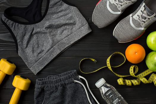 Sports accessories for fitness on the wooden floor. Healthy lifestyle concept. Top view