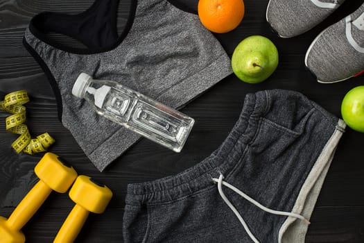 Sports equipment and wear on dark wooden background, top view. Copy space Still life. Ideal for blog.