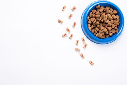 dry pet food in bowl on white background top view. Still life. Copy space
