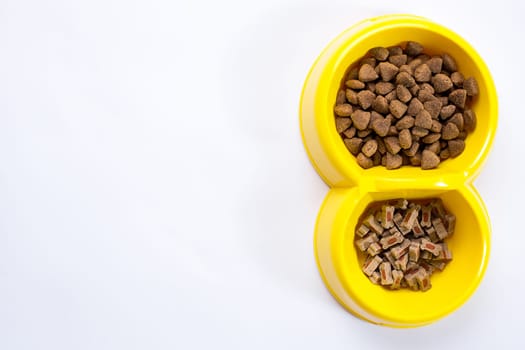 dry pet food in bowl on white background top view. Still life. Copy space