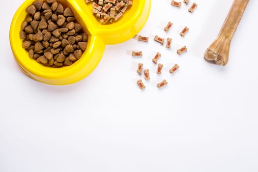 dry pet food in bowl on white background top view. Still life. Copy space