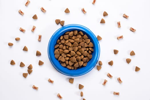 dry pet food in bowl on white background top view. Still life. Copy space