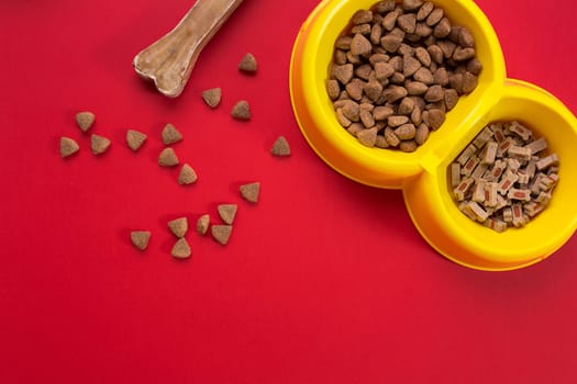 dry pet food in bowl on red background top view. Still life. Copy space