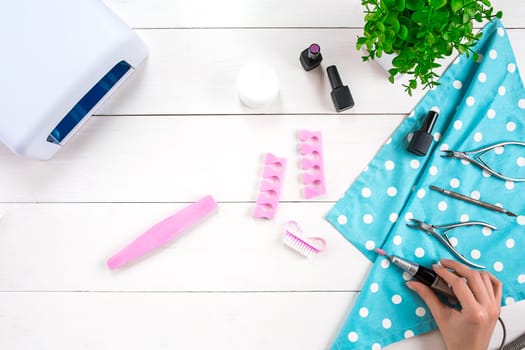 Manicure set and nail polish on wooden background. Top view. Copy space. Still life. Nail Care.