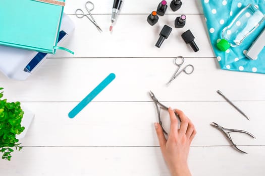 Manicure set and nail polish on wooden background. Top view. Copy space. Still life. Nail Care.