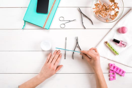 Nail care. Manicure set and nail polish on wooden background. Top view. Manicurist. Manicure for yourself