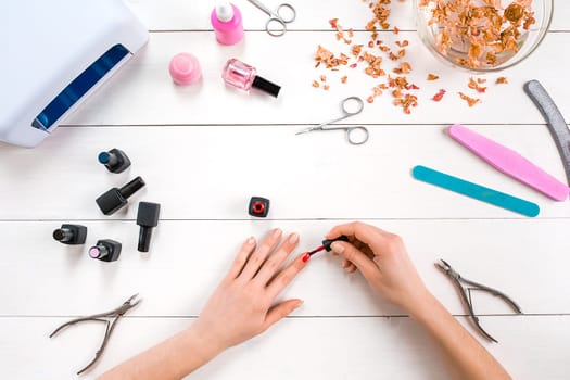 Paint your own nails. Manicure set and nail polish on wooden background. Top view. Copy space. Still life. Nail Care.