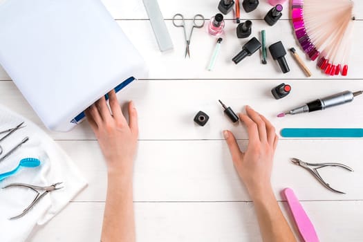 Nail care. Manicure set and nail polish on wooden background. Top view. Manicurist. Manicure for yourself