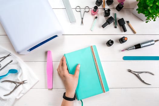 Manicure set and nail polish on wooden background. Top view. Copy space. Still life. Nail Care.