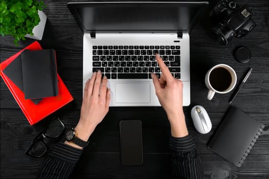 Overhead view of businesswoman working at computer in office. Place for your text. Ideal for blog. Flat lay. Black background