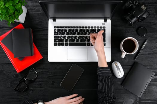 Overhead view of businesswoman working at computer in office. Place for your text. Ideal for blog. flat lay on black background