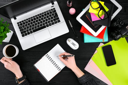 Overhead view of businesswoman working at computer in office. Place for your text. Ideal for blog. flat lay on black background