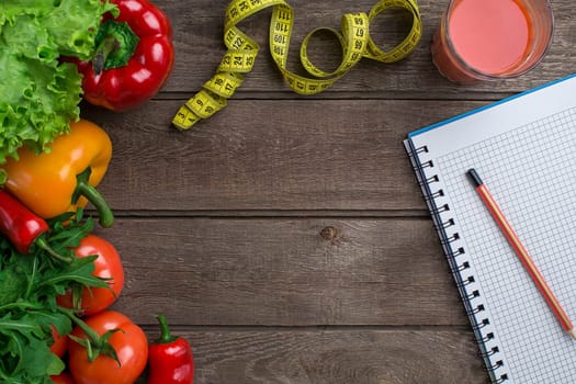 Sport and diet. Vegetables and centimeter. Peppers, tomatoes, salad on rustic background. Top view. Copy space