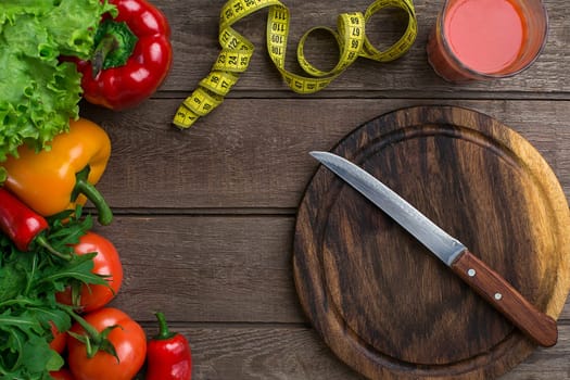 Sport and diet. Vegetables and centimeter. Peppers, tomatoes, salad on rustic background. Top view. Copy space