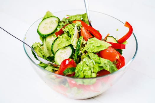 Healthy eating, vegetarian food, dieting and people concept - close up vegetable salad with olive oil on a white background