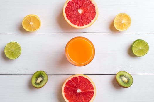 Various citrus fruits with a drink on the table. Top view. Copy space.