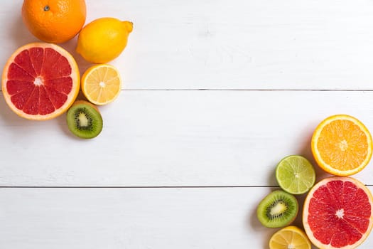 Various citrus fruits on the table. Top view. Copy space.