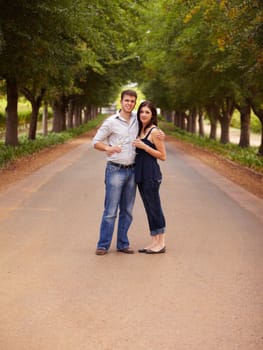 Couple, portrait and wine outdoor at a vineyard for vacation, holiday or travel with love and care. Man and a woman hug on a countryside road with trees, alcohol glass or drinks to celebrate marriage.