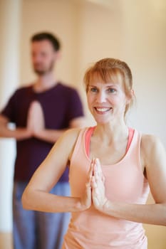 Who doesnt enjoy a good yoga session. a woman doing a yoga class