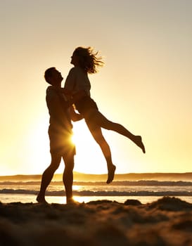 Partners in everything. a romantic couple having fun on the beach at sunset