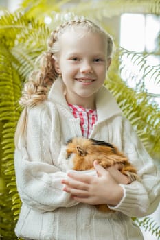 Portrait of pretty smiling little girl posing with pet