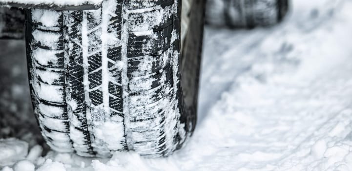 Tire, winter and car driving in snow or ice for a road trip, travel and outdoor journey using transport in cold weather. Ice, transportation and vehicle drive or traveling on a track in nature.