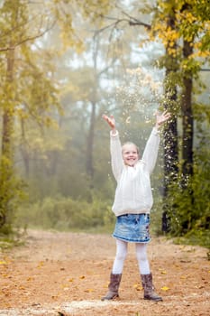 Image of enthusiastic little girl playing in park, close-up
