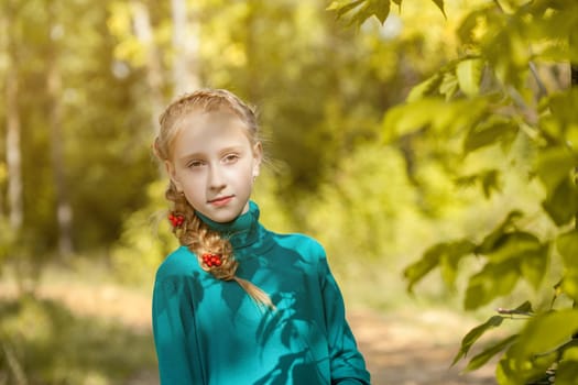 Portrait of charming freckled girl with pigtail, close-up