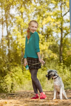 Image of playful little girl posing with puppy, close-up