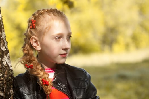 Portrait of cute girl posing with berries in pigtail, close-up
