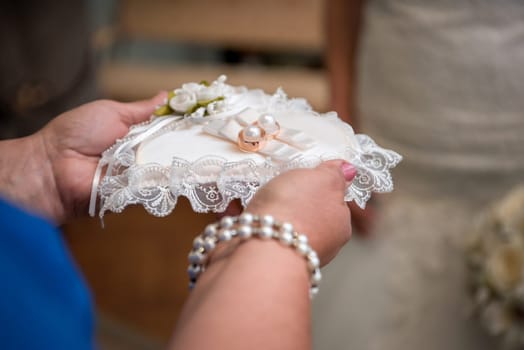 Two gold wedding rings and small flowers