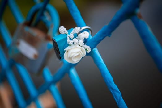 Blue lock wedding decorated with flower rose