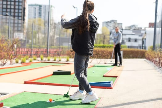 Mini-golf ball on artificial grass. Summer season game.
