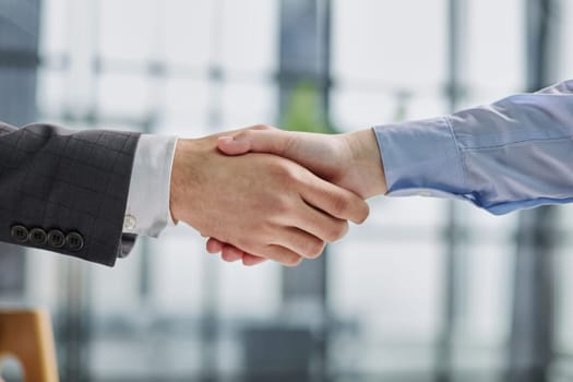 Close up of a handshake against college hallway