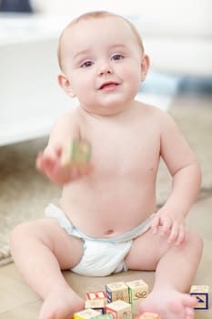 You can have this one. an adorable little boy wearing his diaper while playing with his blocks