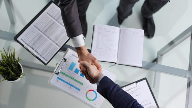 Business people handshake,signing agreement, graph, business charts,success for business deal