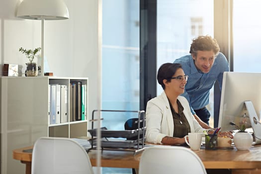 Theyre professionals at problem solving. businesspeople working on a computer in an office