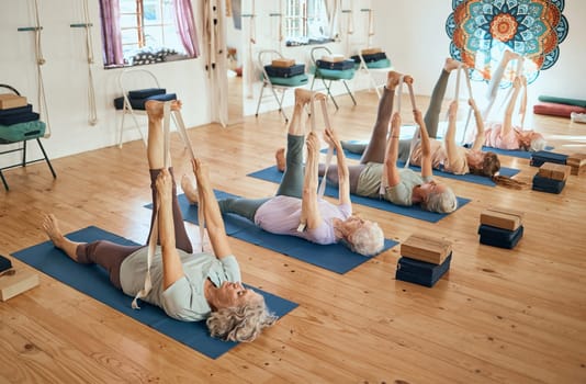 Yoga, stretching and senior women training body for health, exercise and fitness on the floor of a gym. Wellness, relax and group of elderly friends in a workout class for pilates and rehabilitation.