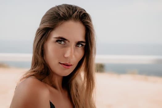 Happy woman portrait in cafe. Boho chic fashion style. Outdoor photo of young happy woman with long hair, sunny weather outdoors sitting in modern cafe