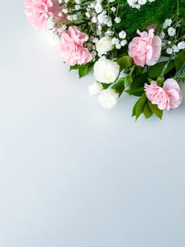 Close up photo of a bouquet of pink and white carnations isolated on a white background. With empty space for text or inscription. For postcard, advertisement or website.