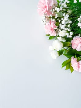 Close up photo of a bouquet of pink and white carnations isolated on a white background. With empty space for text or inscription. For postcard, advertisement or website.